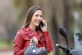 Happy motorbiker calling on phone on a motorbike