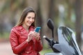 Motorbiker using a smart phone on a motorbike