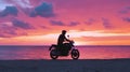 Happy Motorcyclist Rides Bike on Beach at Sunset