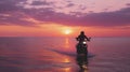 Happy Motorcyclist Rides Bike on Beach at Sunset