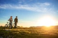 Happy mountainbike couple outdoors have fun together on a summer afternoon sunset Royalty Free Stock Photo