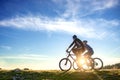 Happy mountainbike couple outdoors have fun together on a summer afternoon sunset Royalty Free Stock Photo