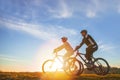 Happy mountainbike couple outdoors have fun together on a summer afternoon sunset Royalty Free Stock Photo