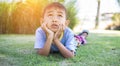 Happy mulatto boy child is smiling enjoying adopted life. Portrait of young boy in nature, park or outdoors. Concept of happy