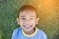 Happy mulatto boy child is smiling enjoying adopted life. Portrait of young boy in nature, park or outdoors. Concept of happy