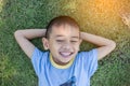 Happy mulatto boy child is smiling enjoying adopted life. Portrait of young boy in nature, park or outdoors. Concept of happy