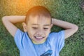 Happy mulatto boy child is smiling enjoying adopted life. Portrait of young boy in nature, park or outdoors. Concept of happy