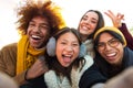 Happy multi-ethnic friends having fun outdoors. Multiracial young group of people taking selfie looking at camera. Royalty Free Stock Photo