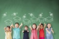 Multi-ethnic group of school children standing in classroom with graduation concept Royalty Free Stock Photo