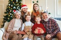 Happy multi generation family celebrating New Year or Christmas Eve together at home near xmas tree Royalty Free Stock Photo