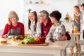 Happy multi generation family with grandparents and grandkids cooking festive Thanksgiving or Christmas meal at kitchen Royalty Free Stock Photo