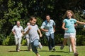 Happy multi generation family racing towards camera Royalty Free Stock Photo