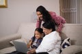 Happy multi-generation family using laptop together Royalty Free Stock Photo