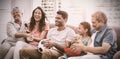 Happy multi-generation family watching soccer match on television in living room Royalty Free Stock Photo