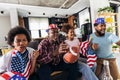 Multi-generation family watching soccer match on television in living room at home Royalty Free Stock Photo