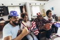 Multi-generation family watching soccer match on television in living room at home Royalty Free Stock Photo