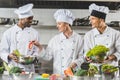 happy multicultural chefs cooking vegetables