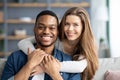 Happy Multicultural Couple Portrait. LovingBlack Man And White Woman Hugging At Home Royalty Free Stock Photo