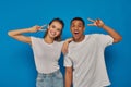 happy multicultural couple showing peace sign Royalty Free Stock Photo