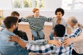 Happy multicultural and different ages group of addicted people discuss problems and together holding shoulders each Royalty Free Stock Photo