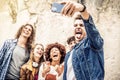 Happy multicultural friends group taking selfie with smart phone mobile outdoors - Millennial people taking picture sharing on Royalty Free Stock Photo