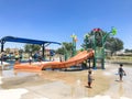 Happy multicultural kids and parent playing at splash park in Texas in post COVID-19 pandemic