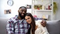 Happy multiethnic couple hugging and looking at camera, relaxing together Royalty Free Stock Photo