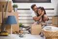 Happy multiethnic couple just moved into new empty apartment unpacking Royalty Free Stock Photo