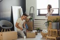 Happy multiethnic couple just moved into new empty apartment unpacking Royalty Free Stock Photo