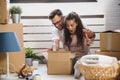 Happy multiethnic couple just moved into new empty apartment unpacking Royalty Free Stock Photo