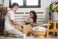 Happy multiethnic couple just moved into new empty apartment unpacking Royalty Free Stock Photo