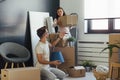 Happy multiethnic couple just moved into new empty apartment unpacking Royalty Free Stock Photo