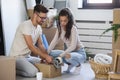 Happy multiethnic couple just moved into new empty apartment unpacking Royalty Free Stock Photo