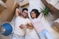 Happy multiethnic couple lying on floor after moving to a new home Royalty Free Stock Photo