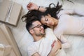 Happy multiethnic couple lying on floor after moving to a new home Royalty Free Stock Photo