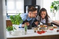 Happy multiethnic couple preparing home made tomato and basil pasta. Cooking at home