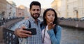 Happy multiethnic couple of tourists taking selfie in old city Royalty Free Stock Photo