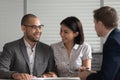 Happy multiethnic couple visiting banker or broker in office Royalty Free Stock Photo