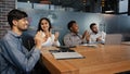 Happy multiethnic employees in office listen training diverse business people multinational team in boardroom applaud Royalty Free Stock Photo