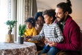 Happy multiethnic family at home taking care for flowers and having fun time together Royalty Free Stock Photo