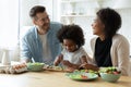 Happy multiethnic family with kid cook together Royalty Free Stock Photo