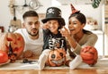 Happy multiethnic family mom, dad and son have fun and celebrate Halloween at home