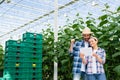 happy multiethnic farmers looking at digital