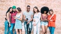 Happy multiethnic friends using smartphone at university college backyard - Young people on addict mood with mobile smart phones Royalty Free Stock Photo