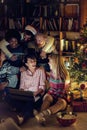 Multiethnic friends watching movie together on laptop on Christmas eve Royalty Free Stock Photo