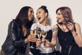 Happy multiethnic girls drinking champagne at party