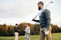 Happy multiethnic golfers spending time together in golf course Royalty Free Stock Photo