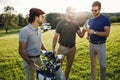 Happy multiethnic golfers spending time together in golf course Royalty Free Stock Photo