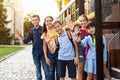 Happy Multiethnic Kids Standing Near School Bus And Waving Hand At Camera Royalty Free Stock Photo