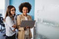 Happy multiethnic smiling business women working together in office